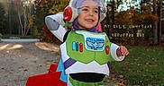 Kane joined the competition — help win amazing prizes! astronaut, autumn, boy, child, costume, forest, full_body, helmet, leaves, nature, outdoor, playful, portrait, smiling, space_ranger, standing, text_overlay, toddler, toy, trees