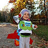 Kane joined the competition — help win amazing prizes! child, toddler, boy, smiling, costume, space_ranger, helmet, astronaut, toy, outdoor, forest, autumn, trees, leaves, nature, portrait, full_body, standing, playful, text_overlay