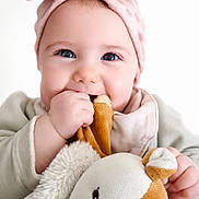 Romy participe au concours pour gagner de l'argent avec cette photo : baby, infant, child, headband, pink, plush_toy, soft_toy, smiling, chewing, cute, portrait, closeup, happy, face, hand, clothing, white_background, adorable, young, indoors