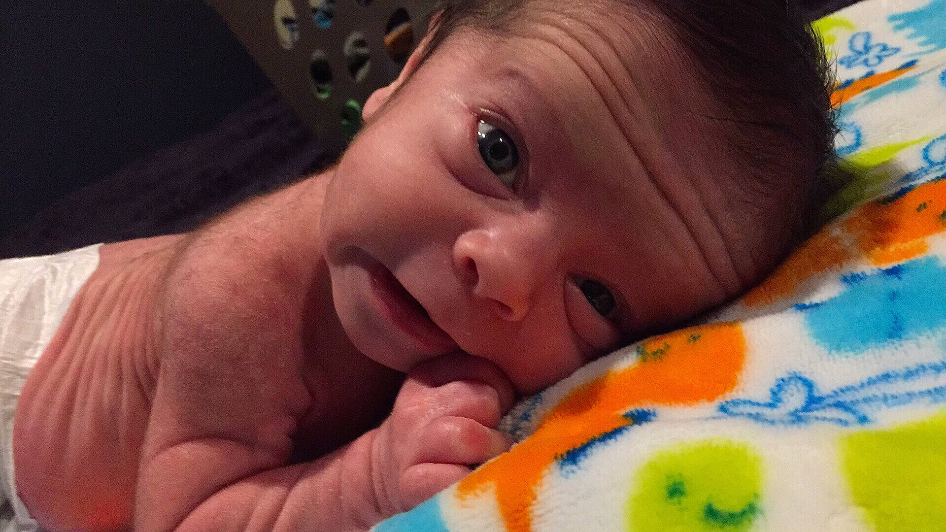 Thatcher is registered to the contest to win money with this photo: bedtime, cheek, child, chin, ear, eye, face, finger, forehead, hand, head, infant, iris, joy, lip, mouth, nose, organ, person, skin