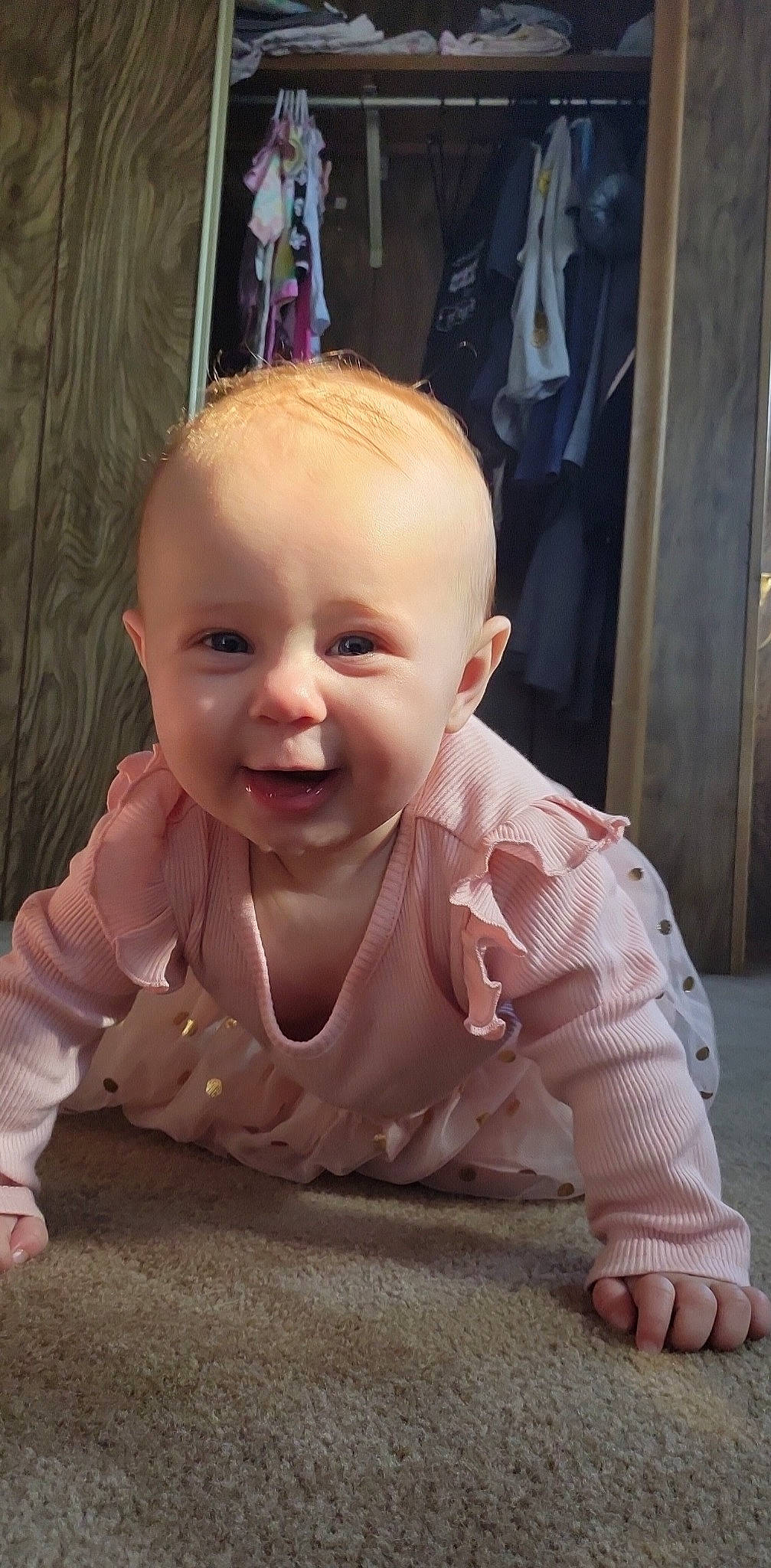 Adaline is registered to the contest to win money with this photo: baby, baby_toddler_clothing, cheek, chin, crawling, eye, eyebrow, flooring, fun, happy, head, iris, lip, mouth, nose, person, pink, skin, smile, toddler