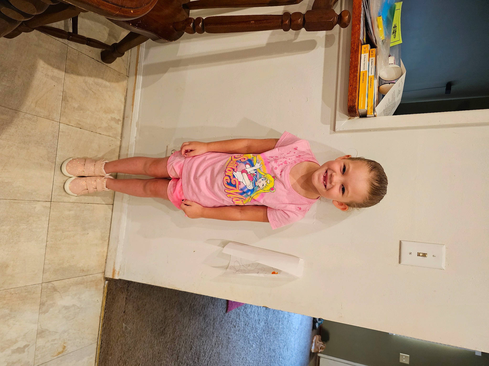 Mckenna is registered to the contest to win money with this photo: baby, baby_products, baby_safety, baby_toddler_clothing, child, comfort, dress, fun, hardwood, joy, person, picture_frame, room, sleeve, smile, t_shirt, toddler, wood