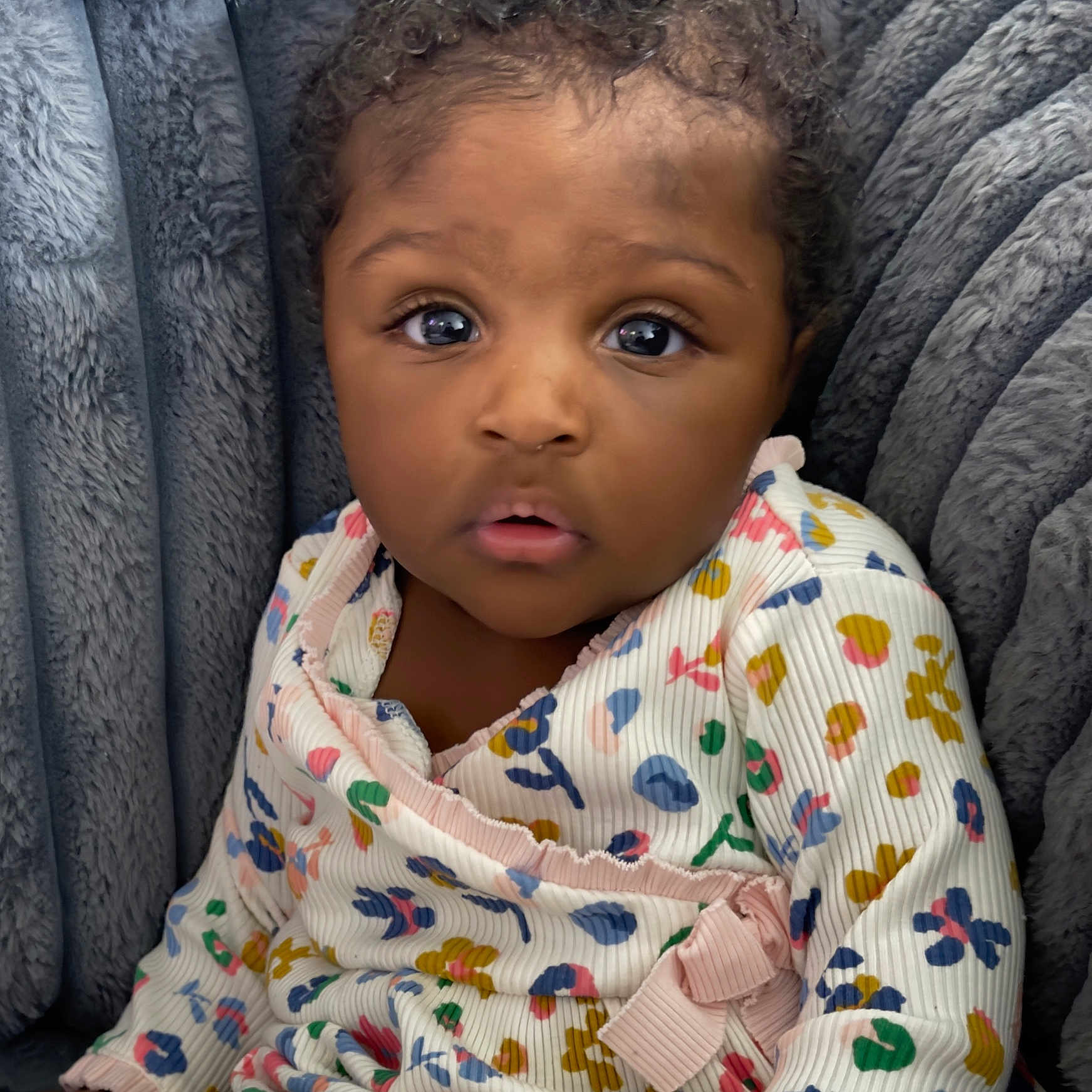 Lea is registered to the contest to win money with this photo: baby, blanket, car, car_interior, carseat, clothing, couch, cushion, dress, face, furniture, happy, head, person, photography, portrait, sitting, smile, transportation, vehicle