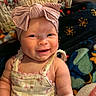 Averi is registered to the contest to win money with this photo: arm, baby, blanket, bow, child, cute, dress, fabric, face, floral, happy, headband, indoors, infant, pattern, person, portrait, quilt, skin, smiling