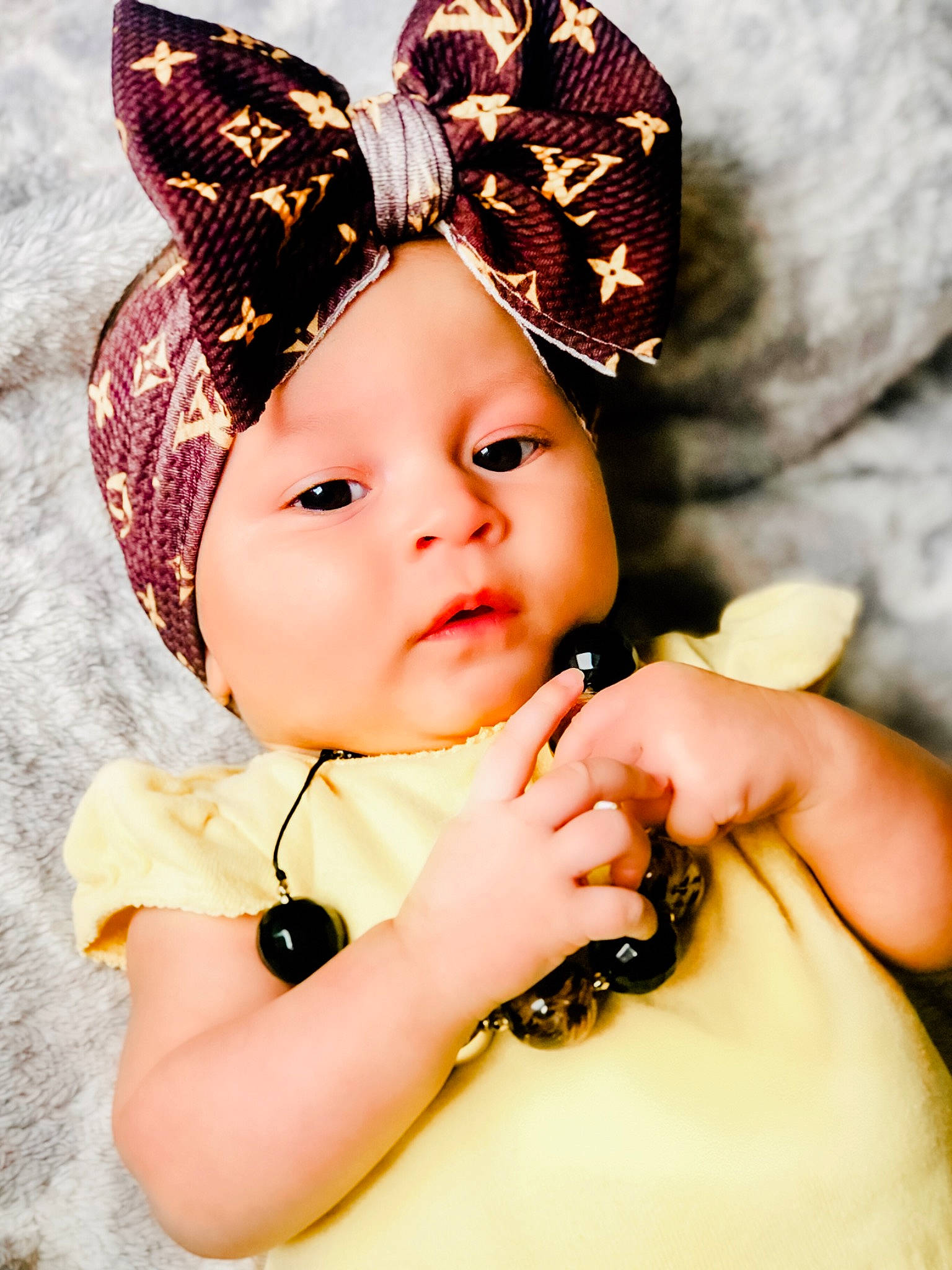 Aliza is registered to the contest to win money with this photo: baby, beauty, cheek, child, child_model, costume_accessory, ear, fashion_accessory, hair_accessory, hand, hat, headgear, headpiece, headwear, lip, organ, person, photography, pink, skin
