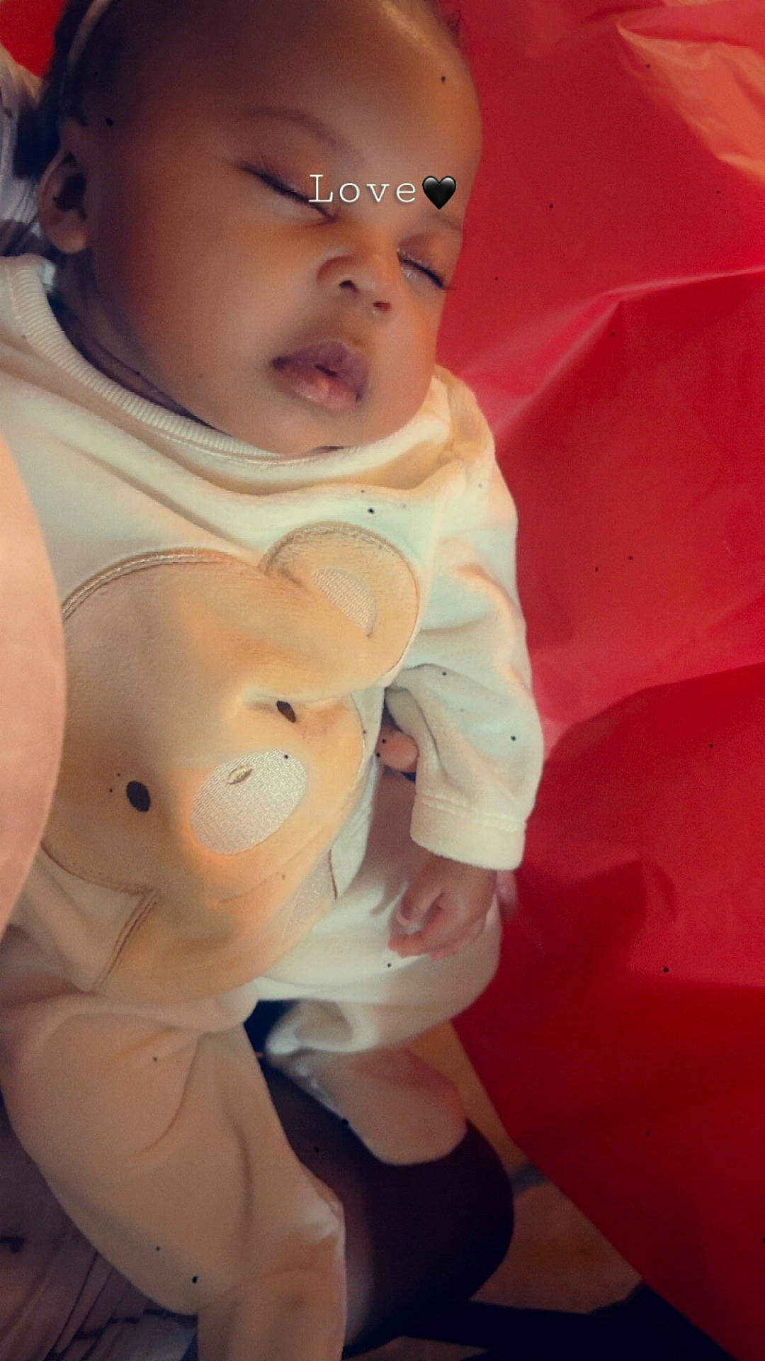 Aria is registered to the contest to win money with this photo: accessories, baby, bodypart, bonnet, clothing, coat, doll, dress, face, finger, frown, hand, hat, head, newborn, pants, person, photography, portrait, toy