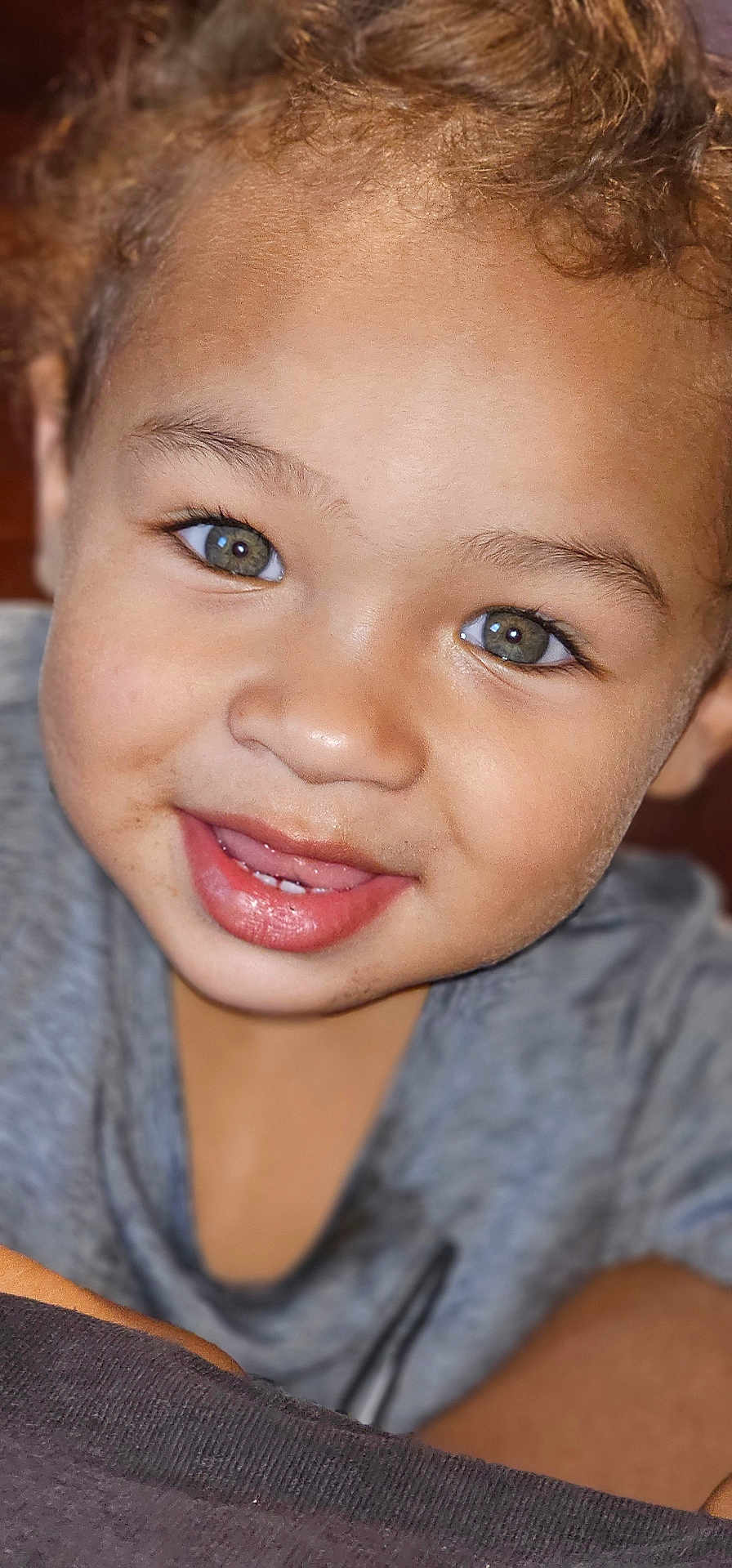 Kingstyn joined the competition — help win amazing prizes! child, toddler, close_up, face, smile, green_eyes, curly_hair, skin, mouth, teeth, clothing, grey_shirt, portrait, cute, happy, person, young, indoor, expression, playful