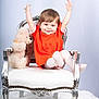 Loredana a rejoint le concours — aidez-le/la à gagner de superbes lots ! arms_raised, carpet, chair, child, cute, fashion, footwear, happy, indoor, orange_dress, person, plush_toy, portrait, silver_chair, smiling, studio, teddy_bear, toddler, white_chair, young_child