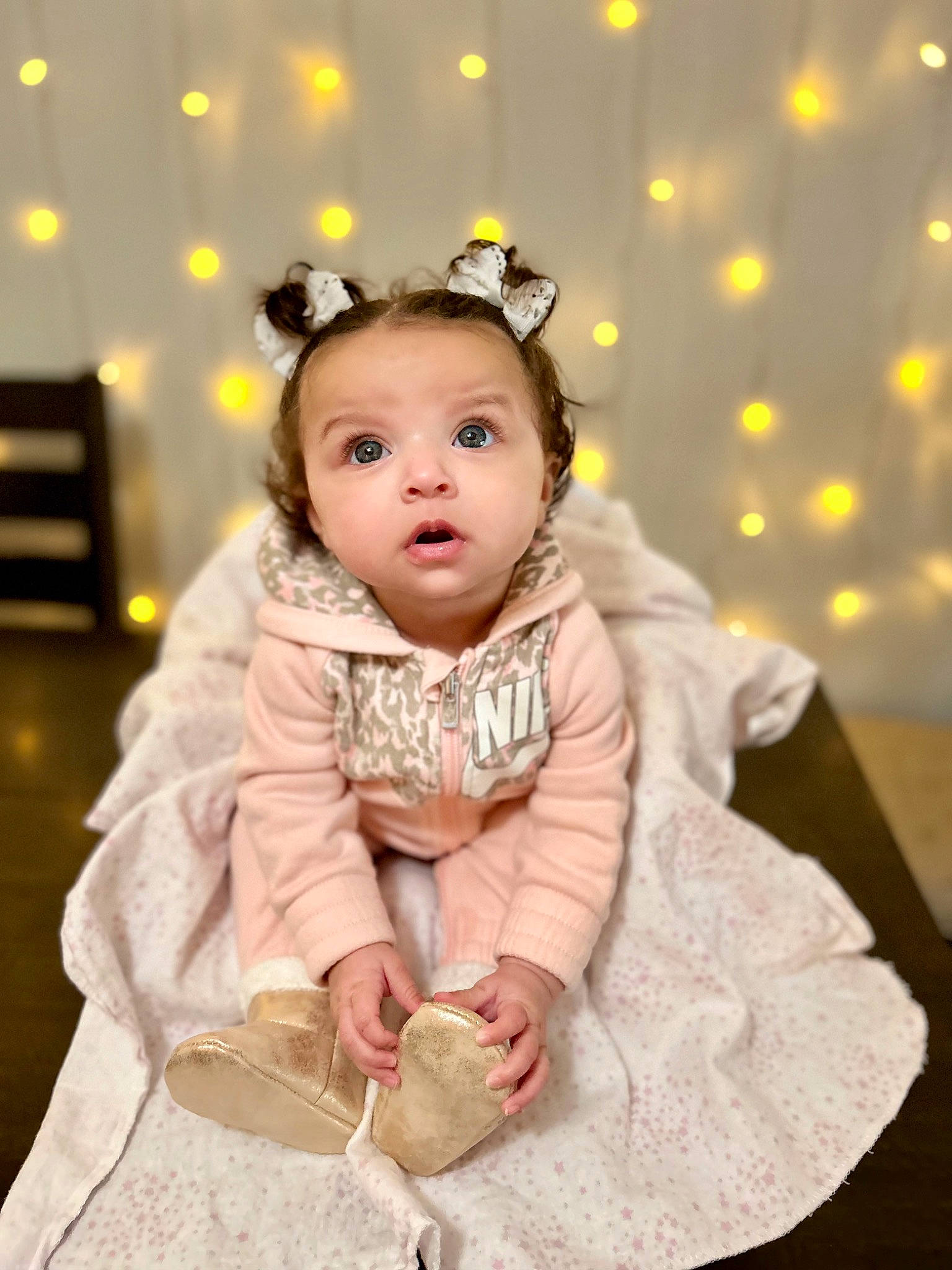 Iyla is registered to the contest to win money with this photo: baby, baby_toddler_clothing, cheek, child, costume_hat, embellishment, event, fashion_accessory, fur, hair_accessory, happy, headband, headpiece, jewellery, pattern, peach, person, pink, sitting, sleeve