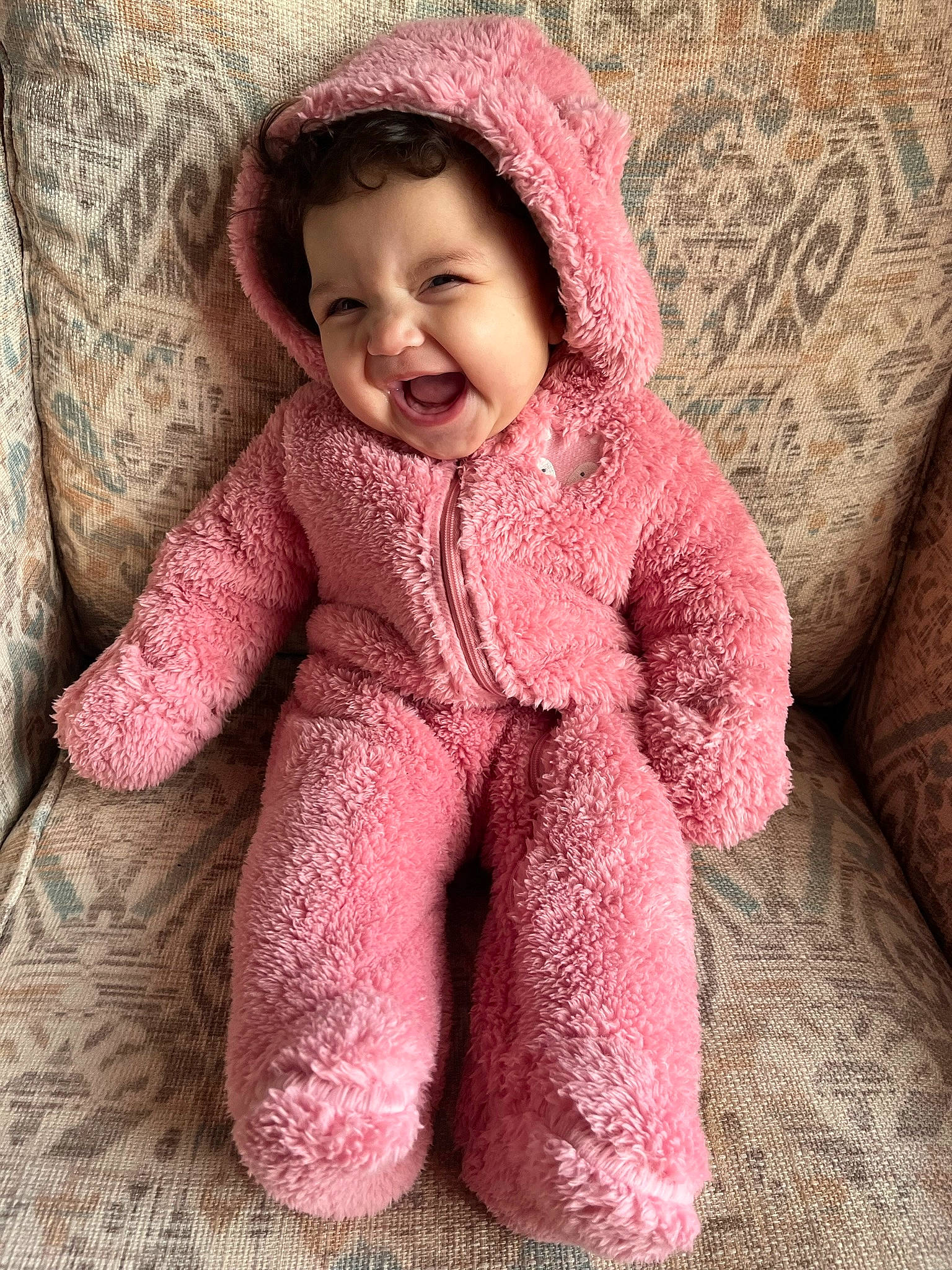 Iyla is registered to the contest to win money with this photo: baby, baby_toddler_clothing, cheek, chin, clothing, eye, eyebrow, face, facial_expression, happy, head, lip, nose, outerwear, person, pink, skin, sleeve, smile, textile