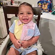 Jahseh is registered to the contest to win money with this photo: toddler, child, high_chair, smiling, indoor, kitchen, colorful_clothing, striped_shirt, baby, happy, seatbelt, furniture, backpack, paw_patrol, counter, cabinet, person, portrait, cute, young_child
