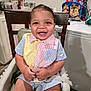 toddler, child, high_chair, smiling, indoor, kitchen, colorful_clothing, striped_shirt, baby, happy, seatbelt, furniture, backpack, paw_patrol, counter, cabinet, person, portrait, cute, young_child