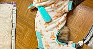 Mo joined the competition — help win amazing prizes! cat, feline, pet, fluffy, long_hair, black_and_white, lying_down, floor, wooden_floor, parquet, clothing, outfit, costume, carrot_pattern, turquoise, paws, tail, indoor, home, funny