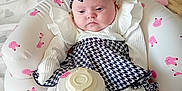 Nevaeh is registered to the contest to win money with this photo: baby, doll, inflatable_chair, bunny_pattern, bow, dress, white_clothing, bottle, indoor, bed, blanket, stuffed_animal, toy, infant, pink, face, headwear, sitting, soft_toys, cute