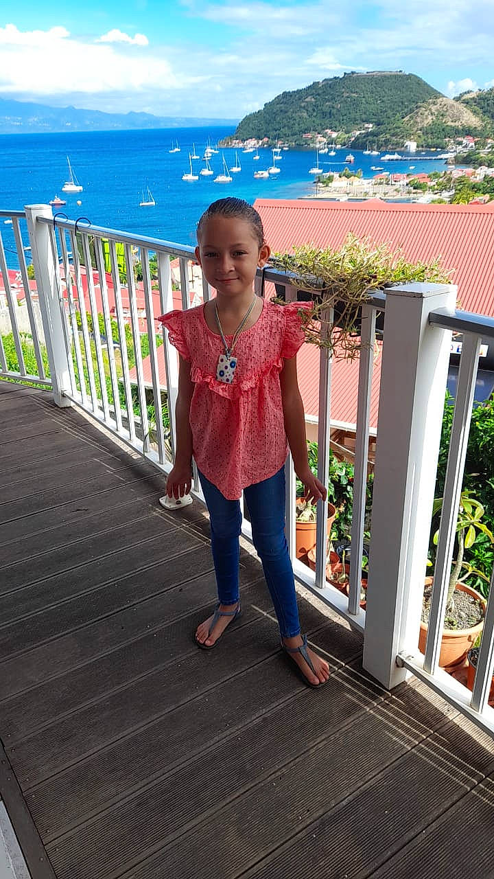 Flora participe au concours pour gagner de l'argent avec cette photo : blue, boardwalk, fence, fun, guard_rail, handrail, happy, joy, leisure, magenta, person, plant, sky, smile, standing, toddler, tourism, travel, tree, walkway