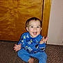 Colton joined the competition — help win amazing prizes! baby, child, pajamas, blue_clothing, smiling, happy, carpet, indoor, door, wooden_door, sitting, clapping, face, person, young_child, floor, home, pajama_set, long_sleeves, infant