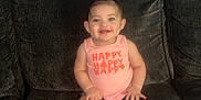 Harper is registered to the contest to win money with this photo: baby, blue_wall, casual_clothing, child, couch, cute, denim_shorts, front_view, hair_tie, happy, indoor, infant, person, pink, portrait, seated, smiling, socks, tank_top, young_child