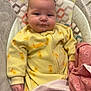 baby, infant, yellow_onesie, duck_prints, blanket, pink_blanket, heart_pattern, baby_seat, cushion, indoor, child, person, cute, cozy, soft_fabric, sleepwear, hand, face, head, comfort