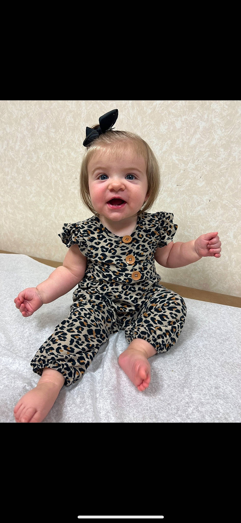 Blakely is registered to the contest to win money with this photo: baby, baby_toddler_clothing, barefoot, collar, finger, floor, flooring, foot, gesture, hair, happy, head, human_leg, person, pink, product, skin, sleeve, smile, thumb