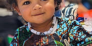 Malik a rejoint le concours — aidez-le/la à gagner de superbes lots ! accessories, applique, baby, bodypart, clothing, dress, face, finger, formalwear, hand, happy, head, jewelry, longsleeve, necklace, person, photography, portrait, sleeve, smile