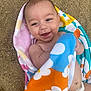 Cruz joined the competition — help win amazing prizes! baby, smiling, towel, colorful, floral_pattern, sand, outdoor, diaper, happy, child, skin, lying_down, cute, playful, summer, portrait, infant, head, expression, bare_chest