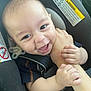 baby, infant, car_seat, child, smile, happy, hands, arm, closeup, face, safety, seatbelt, pacifier, cute, person, young, childhood, playful, secure, bonding