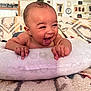 Marley is registered to the contest to win money with this photo: baby, laughing, pillow, blanket, indoor, child, smile, happy, face, skin, person, home, decor, photography, infant, cushion, cute, toddler, wall, frame