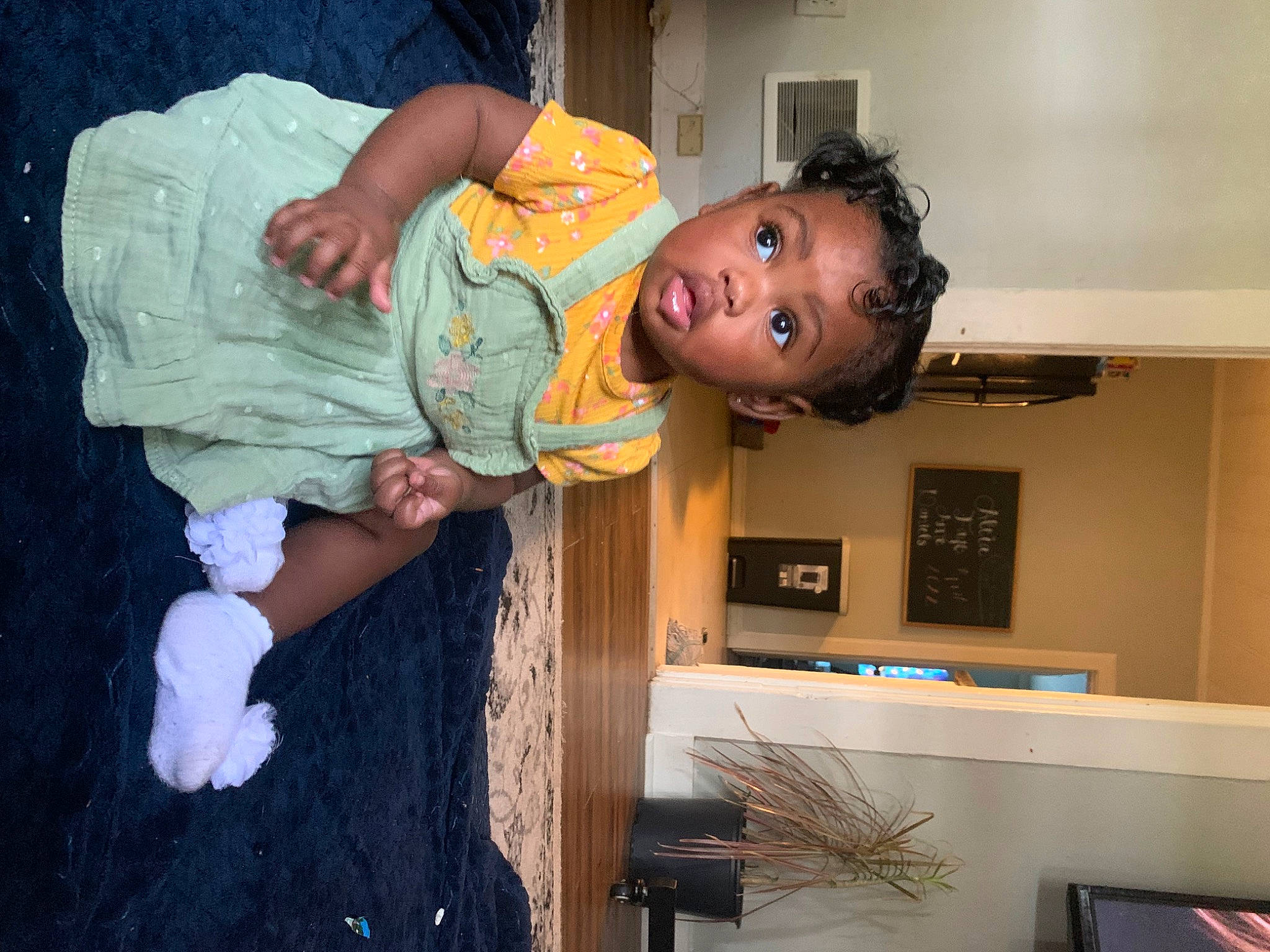 Aleia joined the competition — help win amazing prizes! baby, baby_toddler_clothing, bookcase, cabinetry, child, fun, happy, hardwood, hat, home_appliance, person, picture_frame, room, shelf, shelving, surprise, television, toddler, wood