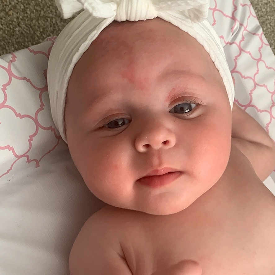 Daisy joined the competition — help win amazing prizes! accessories, baby, bed, bodypart, bonnet, cap, clothing, diaper, face, finger, furniture, hand, hat, head, headband, newborn, person, photography, portrait, towel