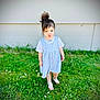 child, girl, grass, greenery, flowers, barefoot, dress, blue_dress, hair_bun, outdoor, playful, pout, young, cute, summer, nature, standing, person, casual, daylight
