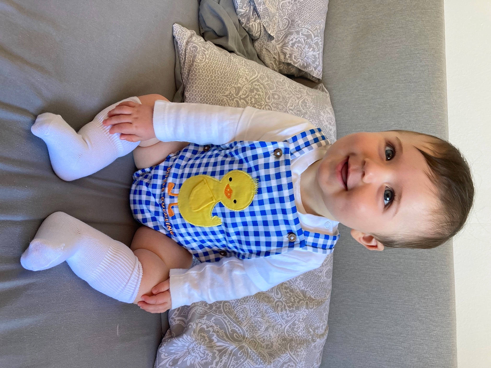 Albert is registered to the contest to win money with this photo: baby, baby_products, baby_toddler_clothing, child, comfort, couch, electric_blue, happy, human_leg, joy, linens, pattern, person, room, sitting, sleeve, smile, sock, textile, thigh