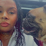 Cookie is registered to the contest to win money with this photo: woman, dog, pug, braided_hair, tattoo, white_jacket, car_interior, sunroof, closeup, portrait, pet, animal, companion, seated, leather_seat, curious, indoors, friendship, expression, side_profile