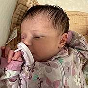 Alana is registered to the contest to win money with this photo: baby, sleeping, pacifier, onesie, floral_pattern, blanket, infant, child, cozy, cute, hand, face, hair, peaceful, resting, indoors, soft_lighting, wallpaper, newborn, quiet