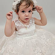 Alaia is registered to the contest to win money with this photo: toddler, child, dress, white_dress, lace, headband, pearl, portrait, cute, small_person, jewelry, necklace, curly_hair, studio, fashion, young_child, innocent, female, person, adorable