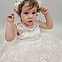 toddler, child, dress, white_dress, lace, headband, pearl, portrait, cute, small_person, jewelry, necklace, curly_hair, studio, fashion, young_child, innocent, female, person, adorable