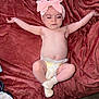 Kodi is registered to the contest to win money with this photo: baby, infant, diaper, headband, pink_bow, blanket, lying_down, sleeping, arms_outstretched, socks, soft_texture, indoors, cute, peaceful, human, child, newborn, resting, cozy, skin