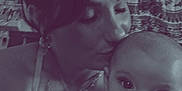 Kodi joined the competition — help win amazing prizes! woman, baby, embrace, love, portrait, indoor, affection, holding, face, expression, person, skin, tattoo, necklace, curly_hair, closeup, intimate, motherhood, infant, bond