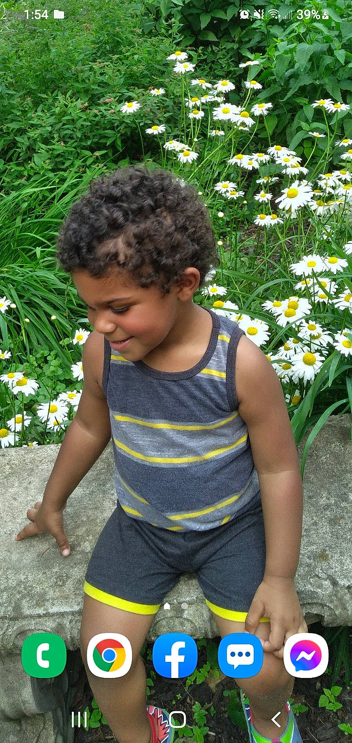 Finnic Blu Norton is registered to the contest to win money with this photo: annual_plant, baby_toddler_clothing, botany, flower, grass, groundcover, hairstyle, happy, leaf, leisure, nature, people_in_nature, person, petal, photograph, plant, shrub, summer, thigh, toddler