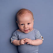 Jonah joined the competition — help win amazing prizes! baby, child, smiling, blue_background, blue_clothing, short_hair, portrait, infant, cute, hands, studio, one_person, young, indoors, happy, looking_at_camera, skin, face, head, sleeves