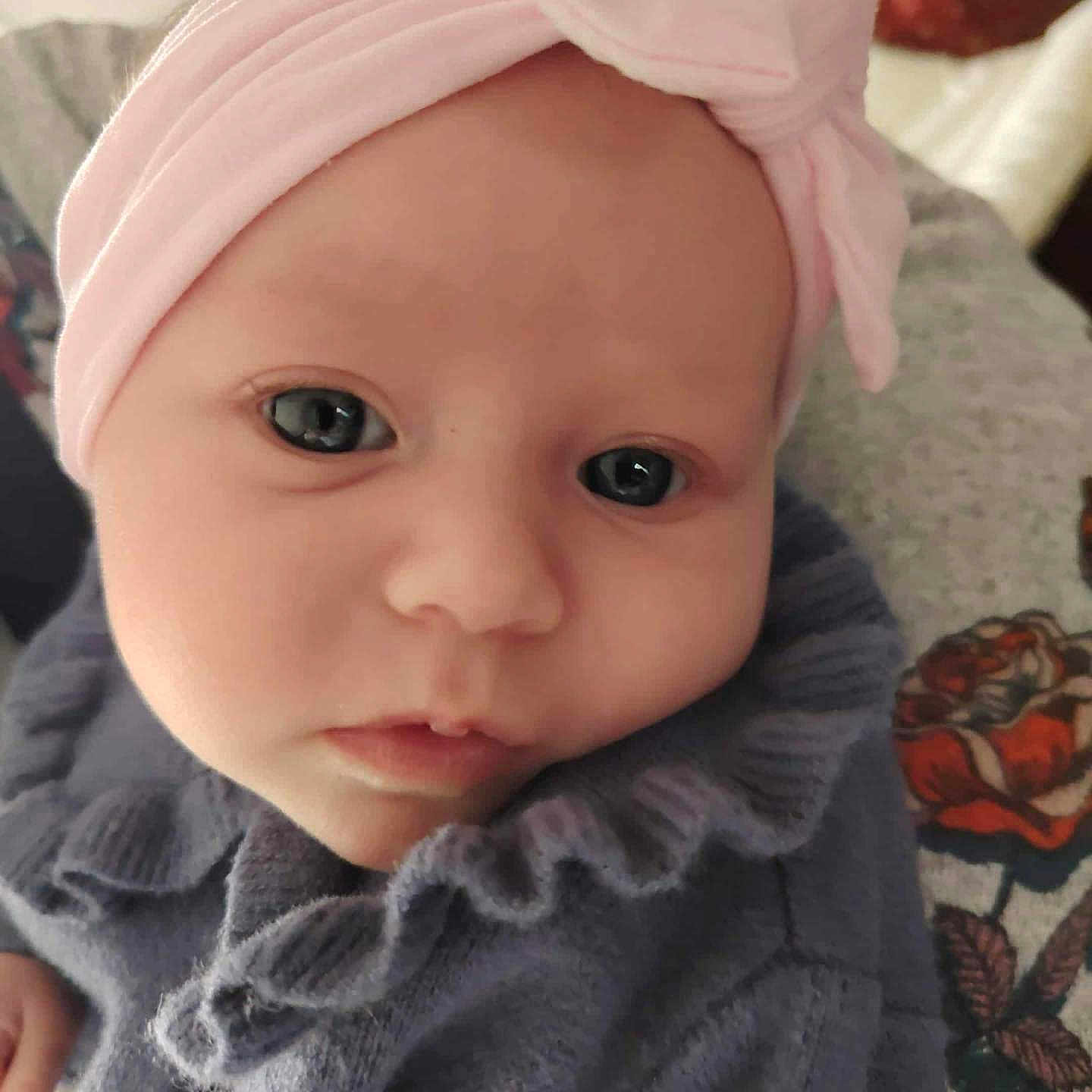 Abigaëlle a rejoint le concours — aidez-le/la à gagner de superbes lots ! baby, blue_eyes, child, closeup, clothing, cute, expression, face, headband, headwear, indoor, infant, newborn, person, pink, portrait, ruffle, soft, sweater, warm