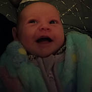 Abigaëlle participe au concours pour gagner de l'argent avec cette photo : baby, infant, blanket, clothing, face, expression, portrait, child, indoors, soft_texture, smiling, happy, warm, cute, person, closeup, head, young, newborn, cozy