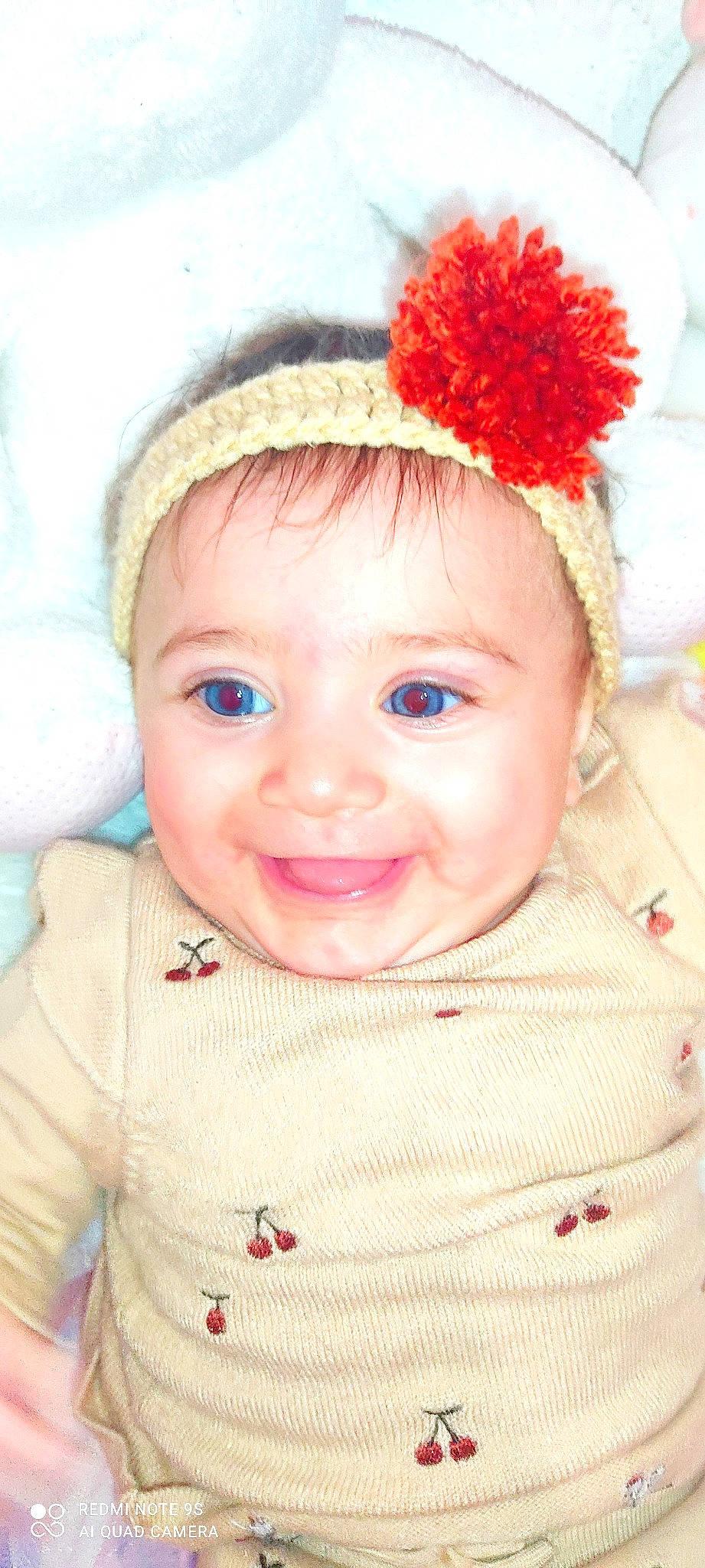 Sylvana participe au concours pour gagner de l'argent avec cette photo : baby, baby_toddler_clothing, cap, cheek, chin, eye, eyelash, flower, happy, iris, joy, lip, nose, organ, outerwear, person, pink, plant, skin, sleeve