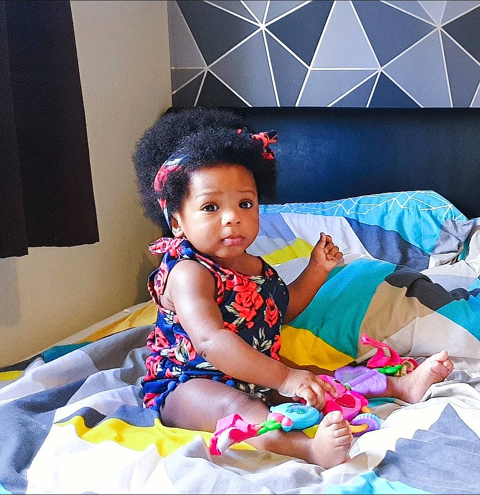 Carina is registered to the contest to win money with this photo: azure, baby, baby_toddler_clothing, comfort, dress, electric_blue, event, fashion_design, happy, human_leg, lap, leisure, magenta, pattern, person, pink, purple, t_shirt, textile, thigh