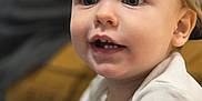 Keith is registered to the contest to win money with this photo: toddler, child, face, blue_eyes, curious, white_shirt, indoor, portrait, close_up, expression, cute, young_child, person, skin, hair, sitting, candid, innocence, mouth_open, looking