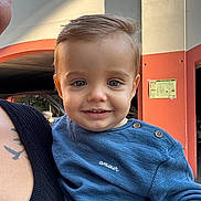Hugo a rejoint le concours — aidez-le/la à gagner de superbes lots ! toddler, child, smile, face, blue_sweater, buttons, amour, adult, tattoo, shoulder, urban, background, car, parking_garage, person, portrait, daylight, holding, happy, closeup