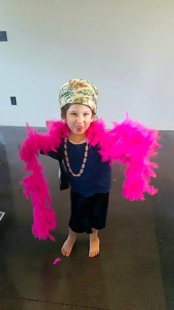 Evelyn is registered to the contest to win money with this photo: child, costume, costume_accessory, costume_hat, entertainment, event, fashion_accessory, fashion_design, feather, feather_boa, fun, fur, happy, headpiece, headwear, joy, magenta, party_supply, person, pink