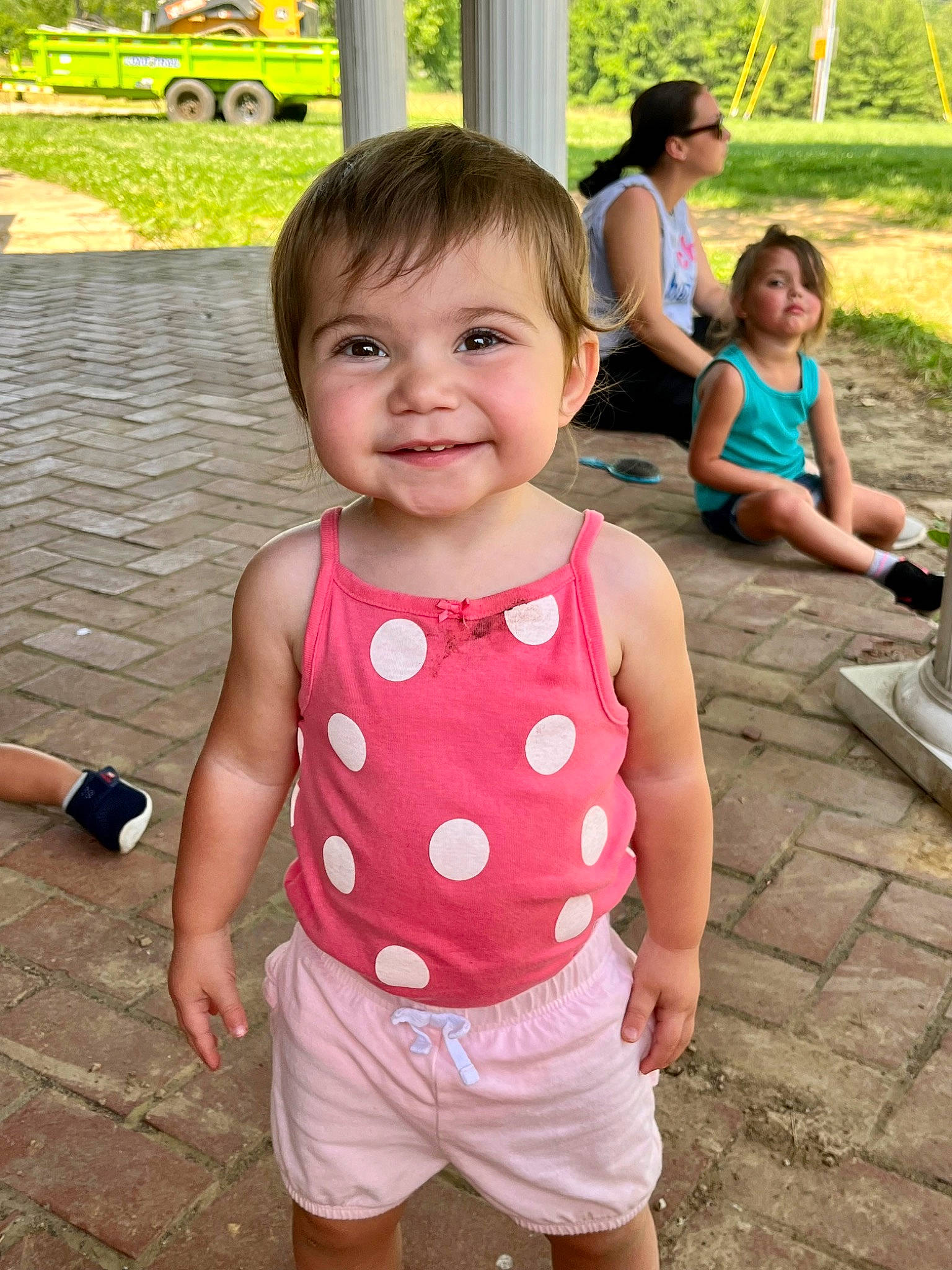 Ashtyn is registered to the contest to win money with this photo: arm, baby_toddler_clothing, chin, clothing, face, green, hair, hand, happy, head, human_body, joint, joy, leg, person, pink, plant, shorts, skin, sleeve