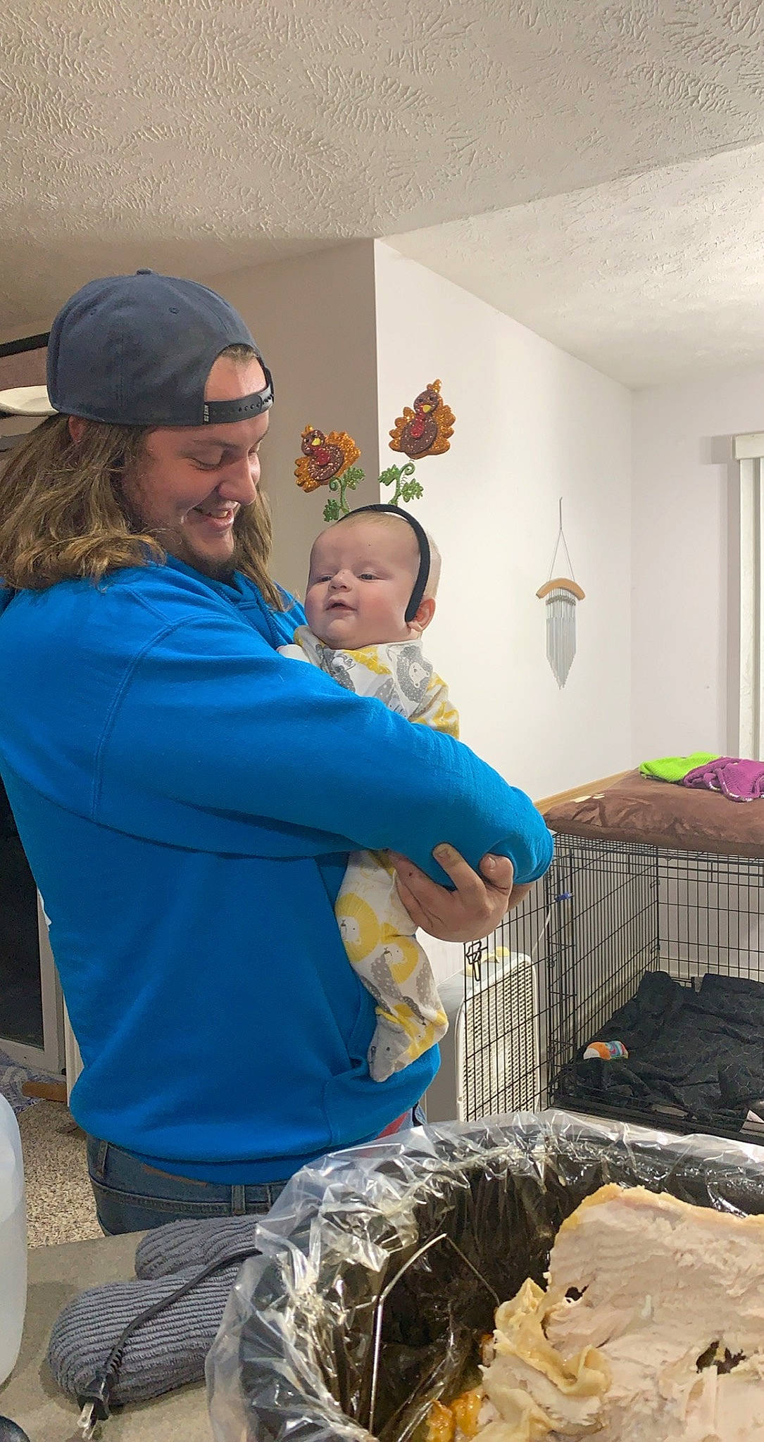 Jaxx is registered to the contest to win money with this photo: baby, baseball_cap, cap, child, community, electric_blue, event, eyewear, fun, happy, headwear, holiday, joy, leisure, person, room, sitting, smile, soil, t_shirt