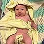 baby, towel, yellow, hood, winnie_the_pooh, knitted_blanket, green, cream, smiling, happy, infant, skin, blanket, cute, child, person, lying_down, indoors, cozy, soft