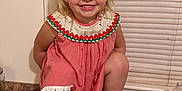 Hollis is registered to the contest to win money with this photo: toddler, child, smiling, blonde_hair, dress, red_and_white, kitchen_counter, barefoot, window_blinds, water_bottle, indoor, happy, cute, portrait, person, flooring, playful, crouching, clothing, hair_tied